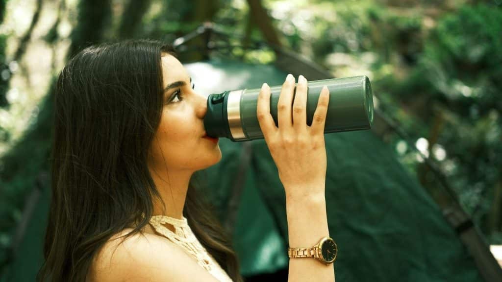 Woman drinking from a tumbler