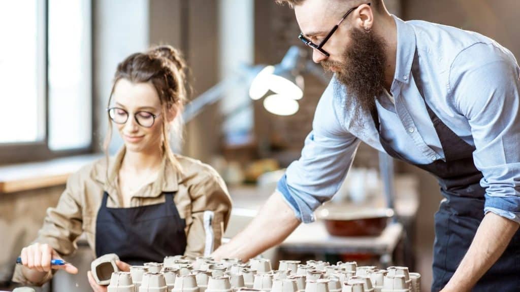 A man and woman at the pottery workshop