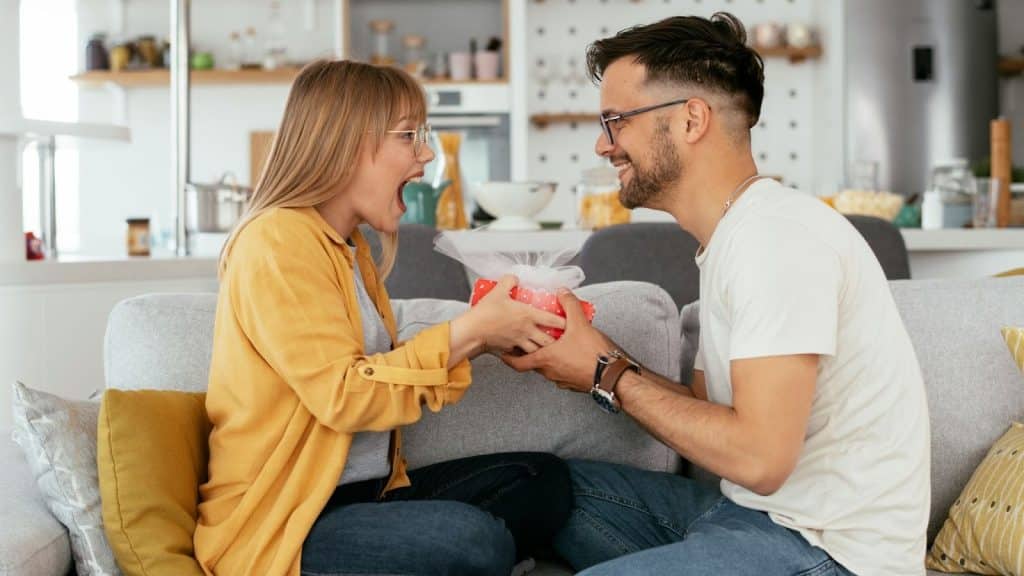 A man giving a gift from a woman 