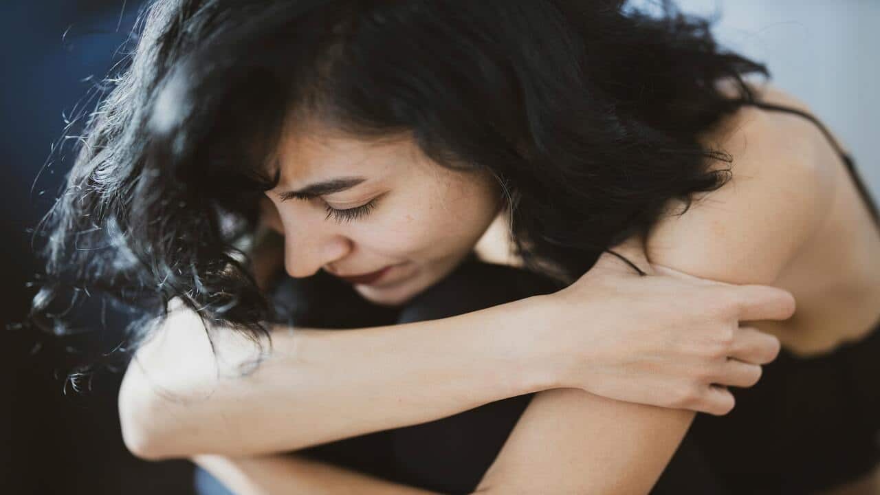 A woman crying at home