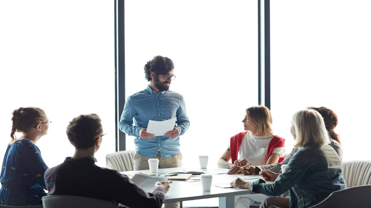 A man leading a team meeting