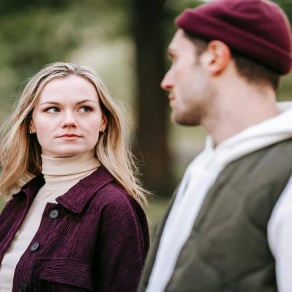 A couple looking at each other in the park