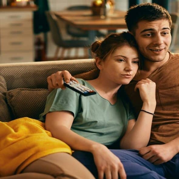 A couple watching TV at home