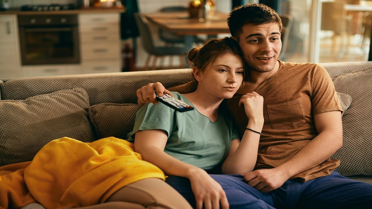 A couple watching TV at home