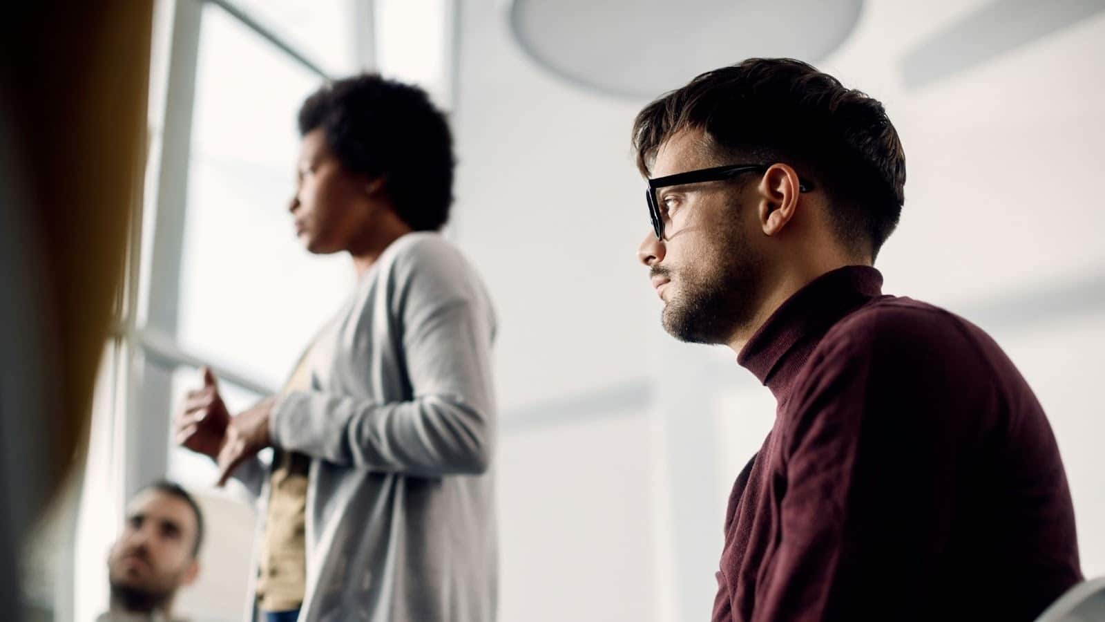 A man quiet and a woman looking outside the window
