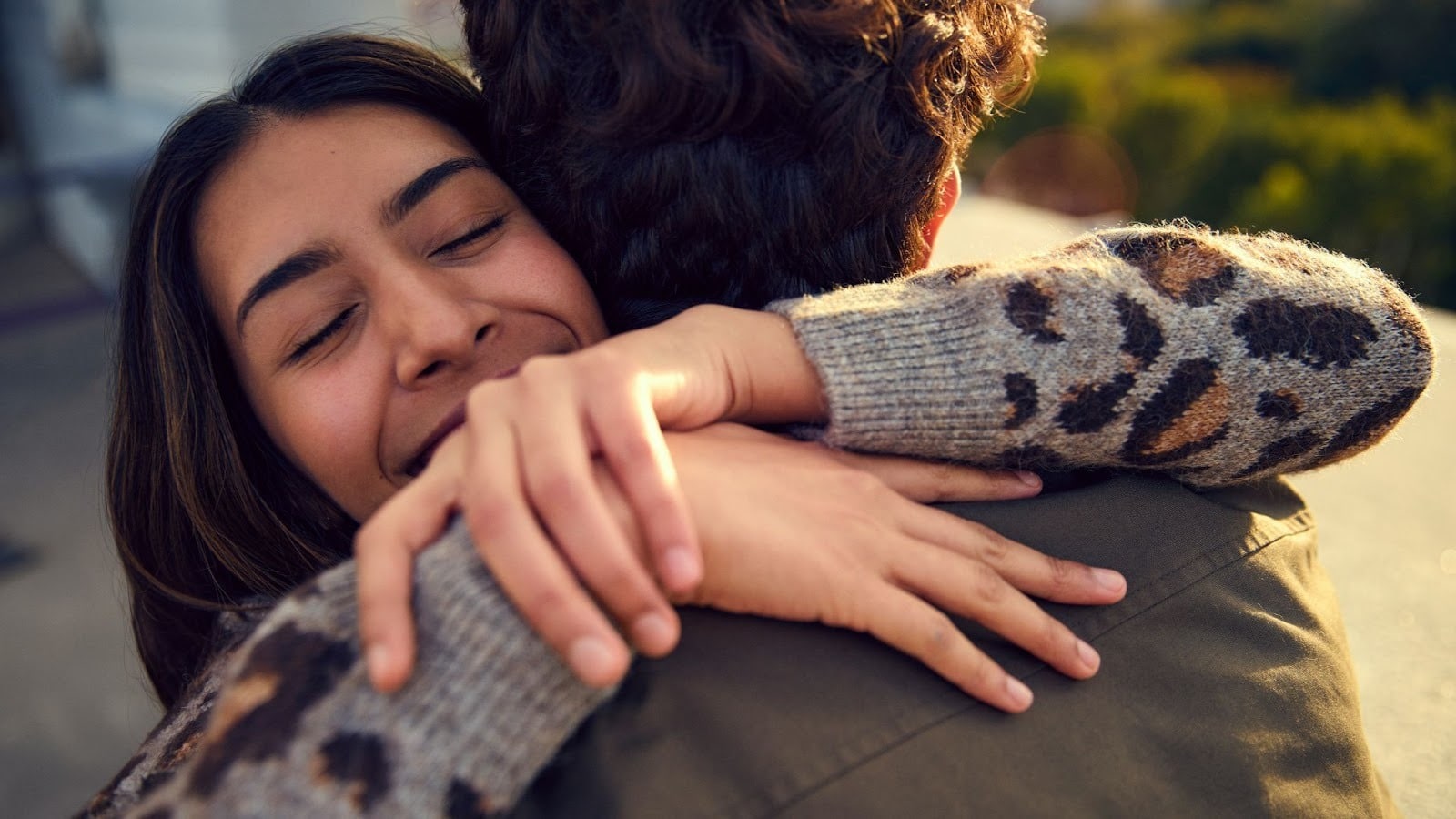 A woman hugging a man 