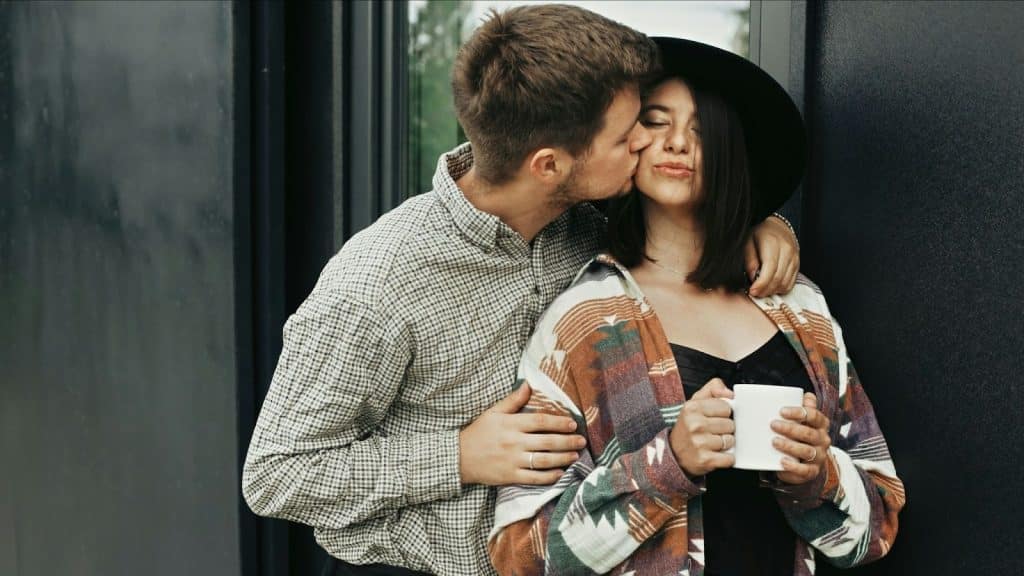 A man kissing woman’s cheek