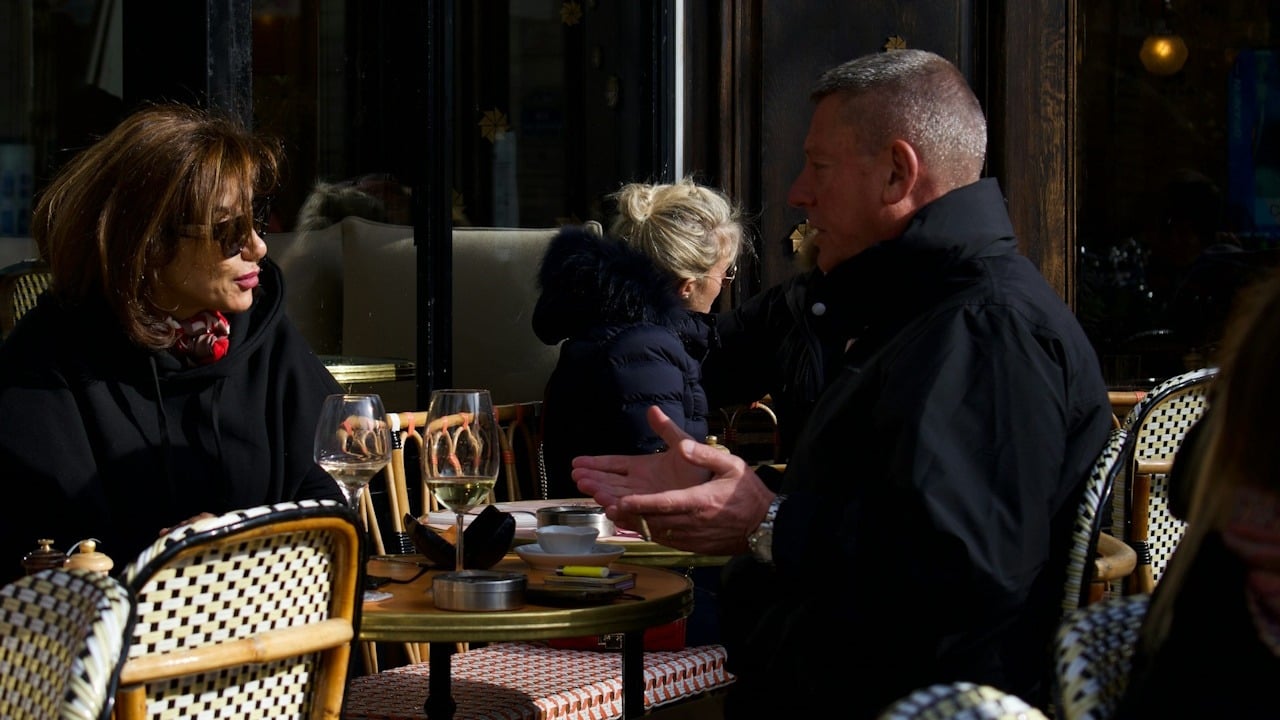 A group people sitting at a table outside.