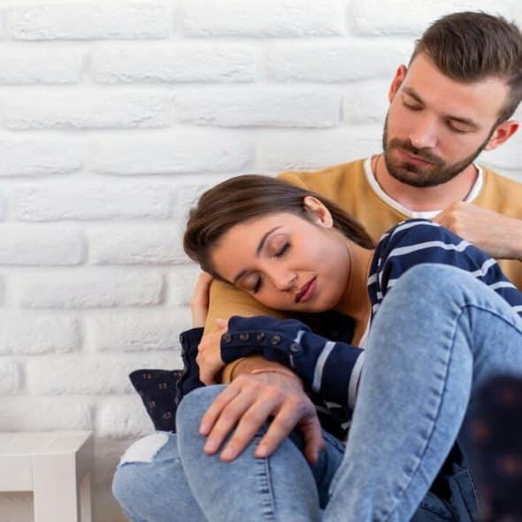 A couple cuddling at home