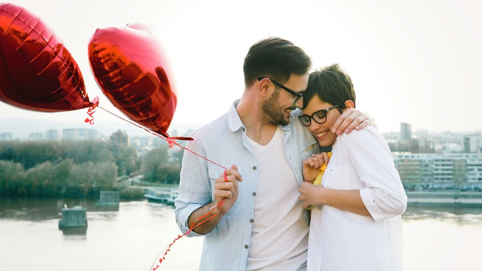 A man giving a balloon heart shaped to woman