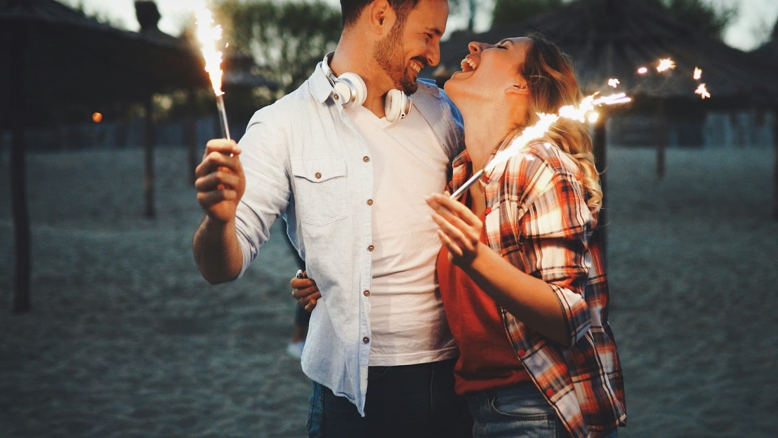 A man and woman holding sparklers