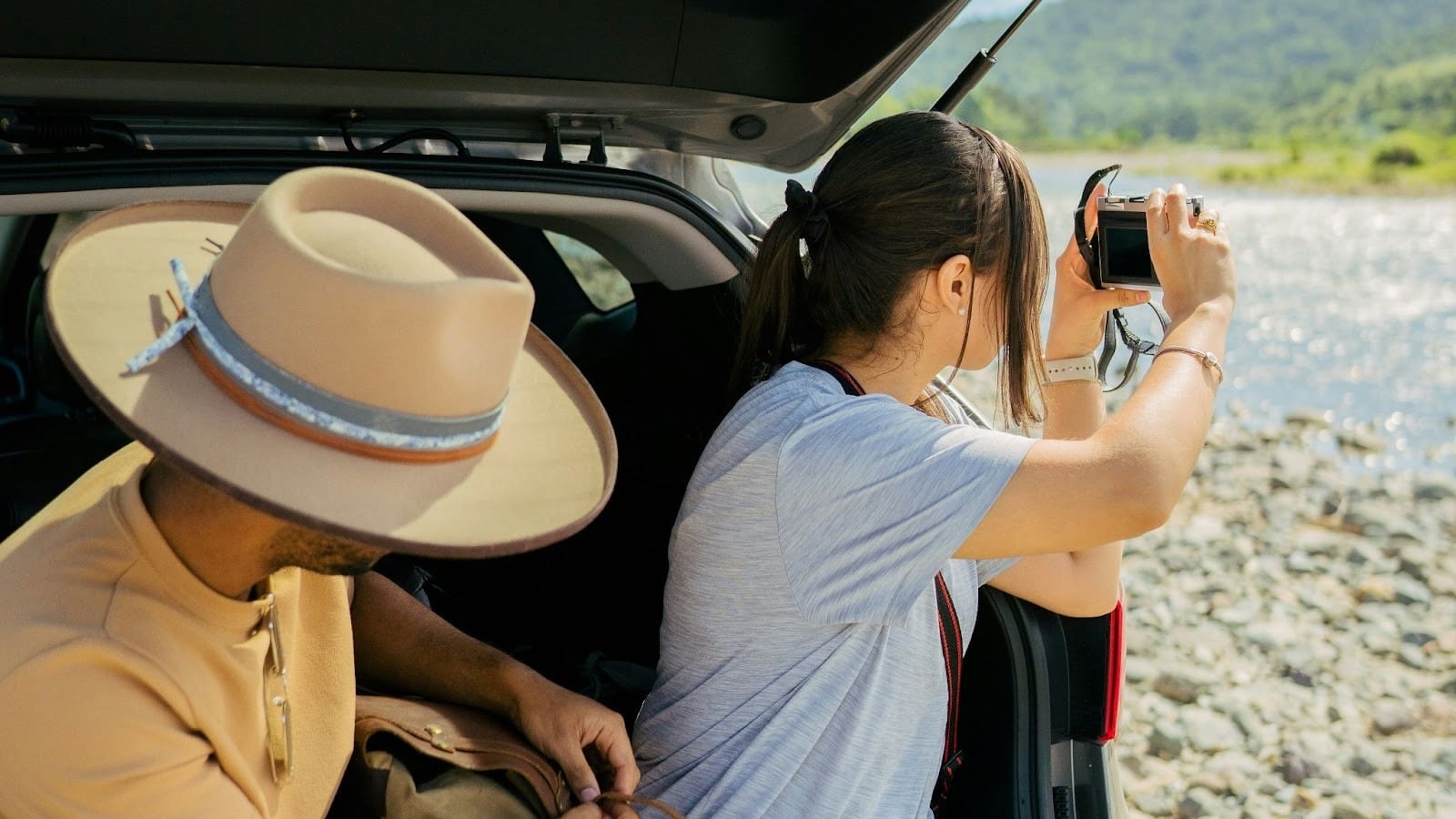 A man and woman at the back of the car