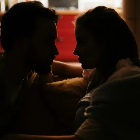 A silhouette of a couple looking at each other
