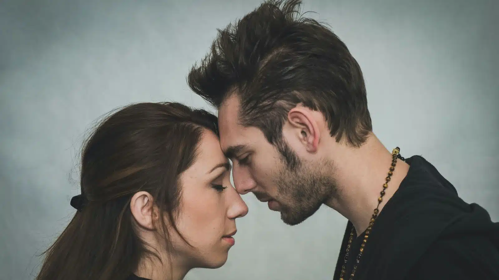 A man and woman closely facing each other