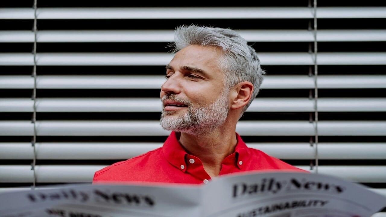 A handsome mature man reading the paper