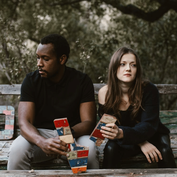Couple in park ignoring each other