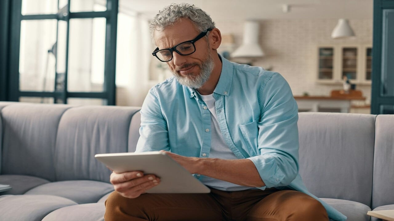 A mature man using his tablet