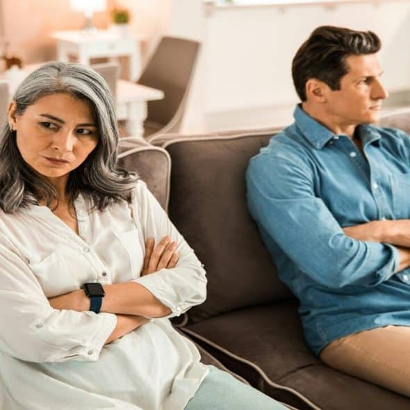 A couple looking upset at home