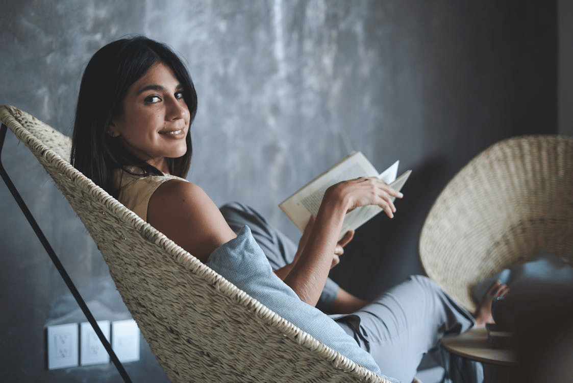 A woman smiling while holding a book