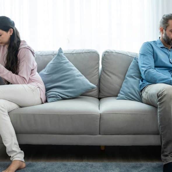 A man and woman busy with their own phone
