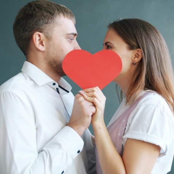 A man and woman holding a heart shaped