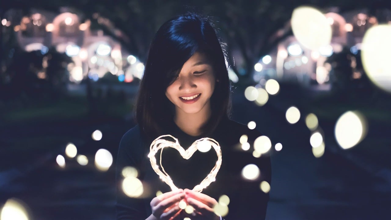 A woman holding a heart.