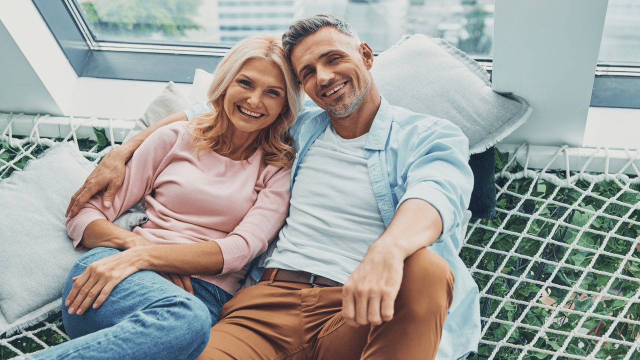 A mature couple smiling at the camera