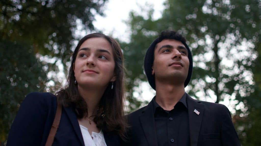 A man and woman standing outdoors.