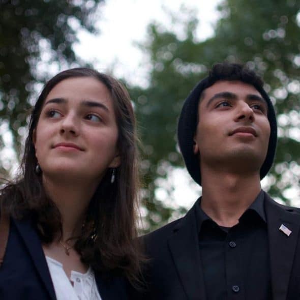 A man and woman standing outdoors.