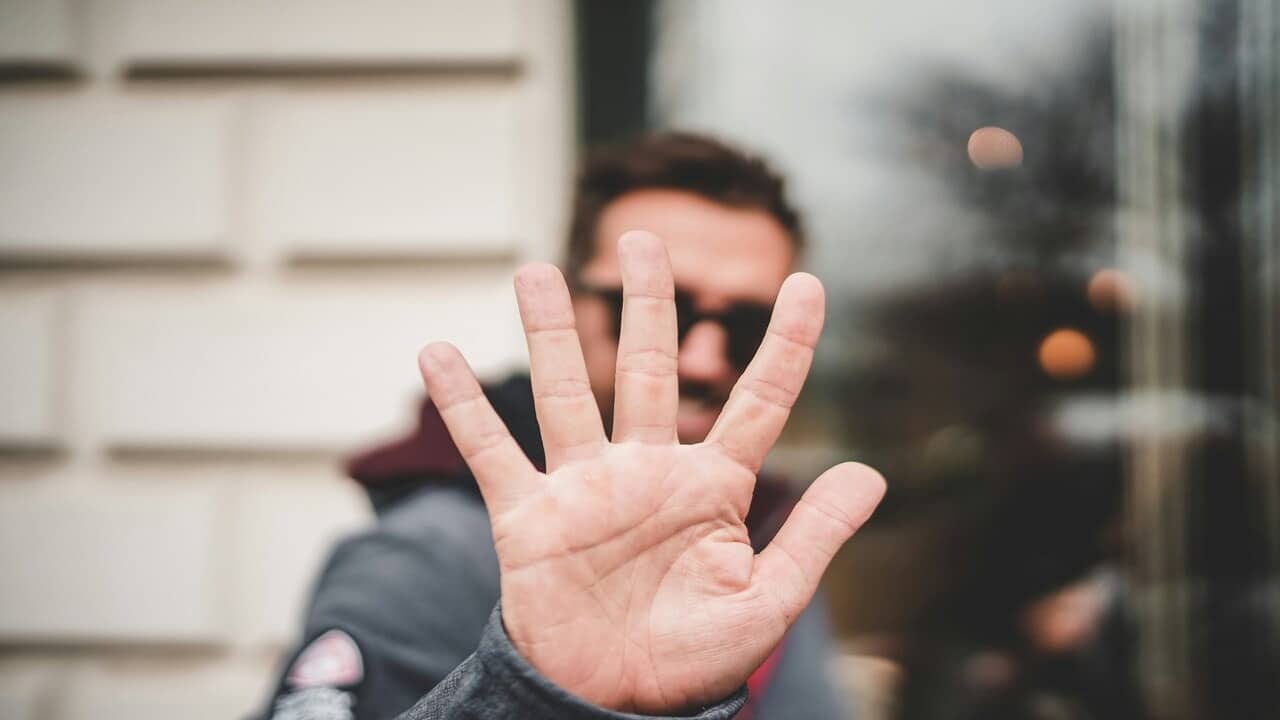 A man saying “no” with his hand