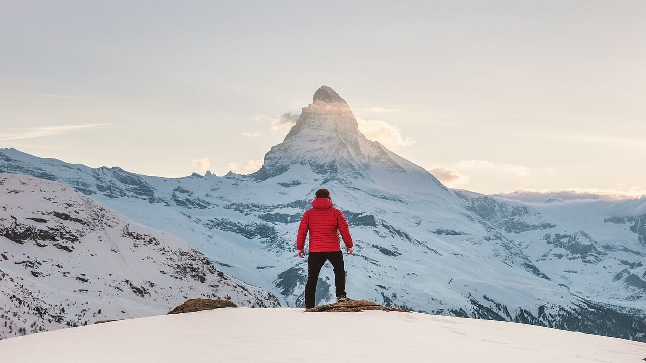 A man on top of a snowy mountain
