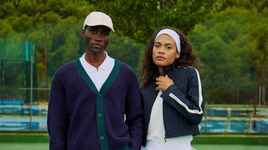 A man and a woman standing on a tennis court.