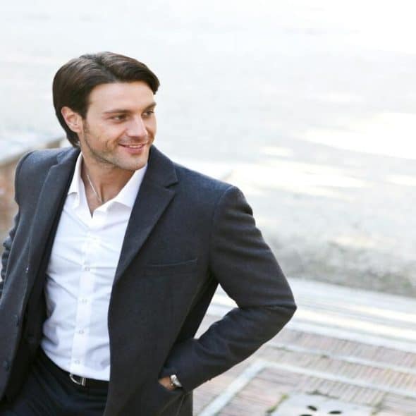 A man standing confidently outdoors