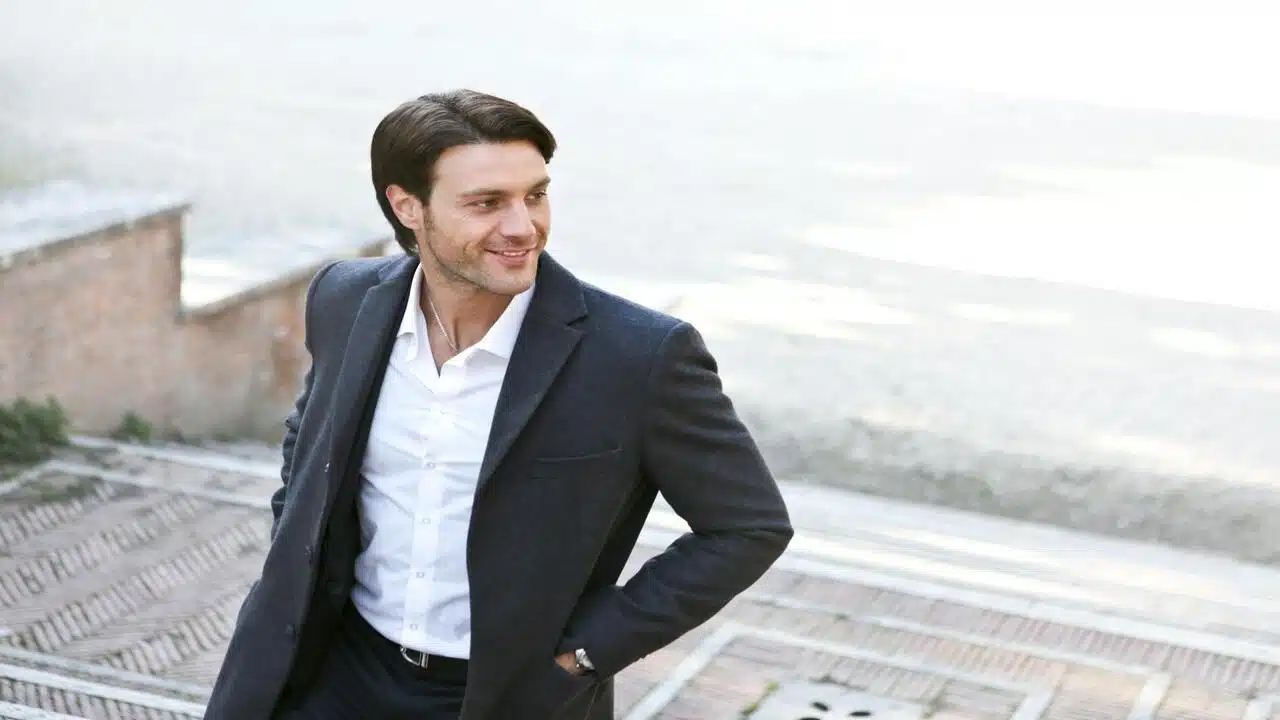 A man standing confidently outdoors