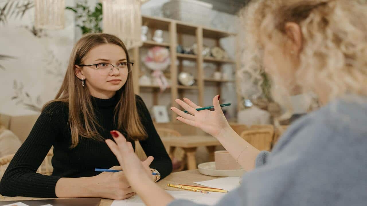 A woman listening to her colleague