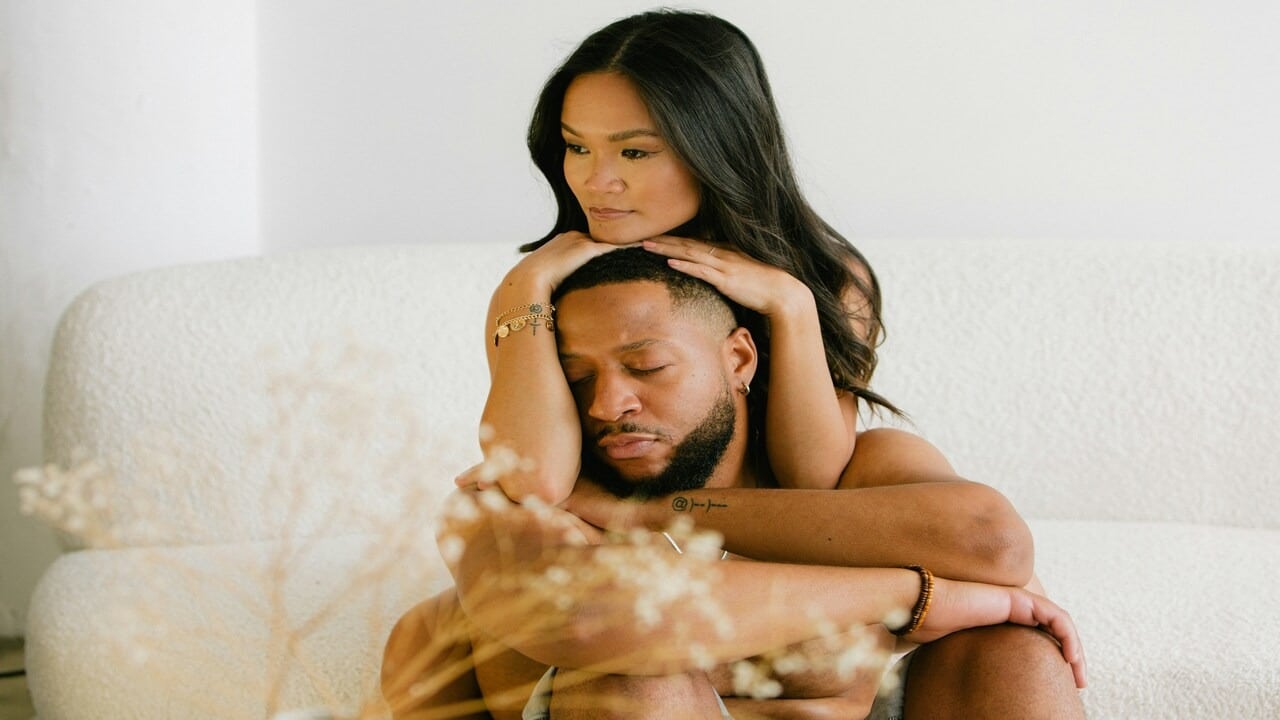 A couple looking sad at home