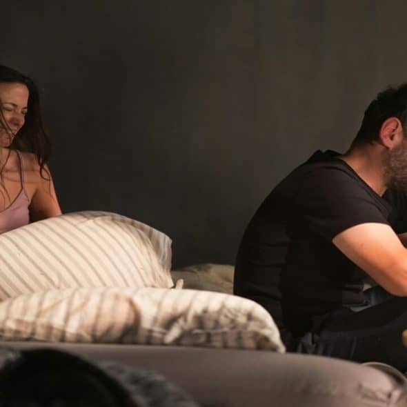A couple crying in bed