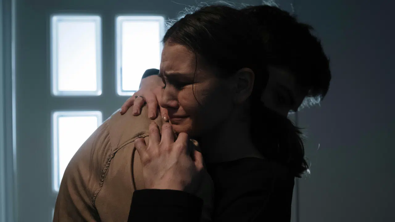 A man hugging his upset wife
