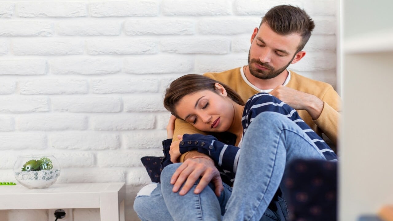 A couple cuddling at home