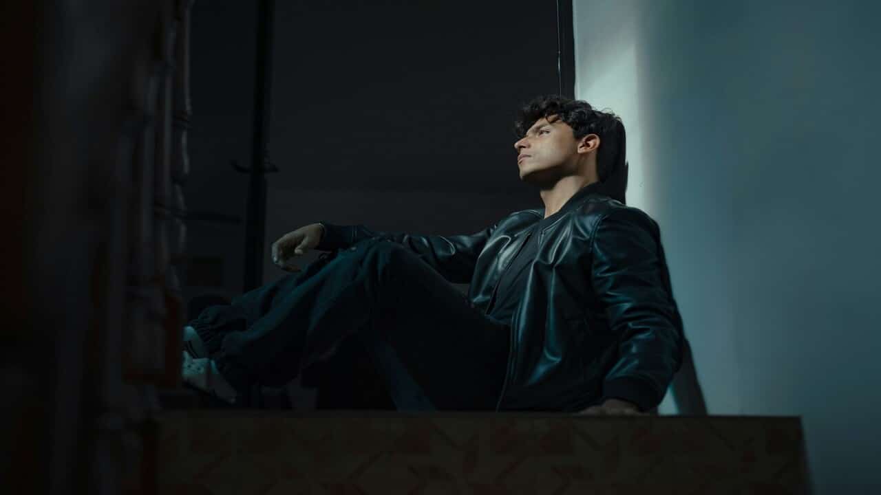 A man sitting alone in a dark room