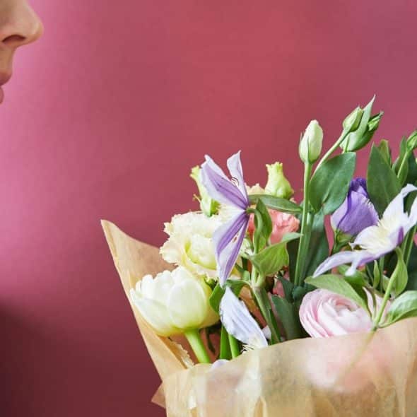 A man holding a flower bouquet.