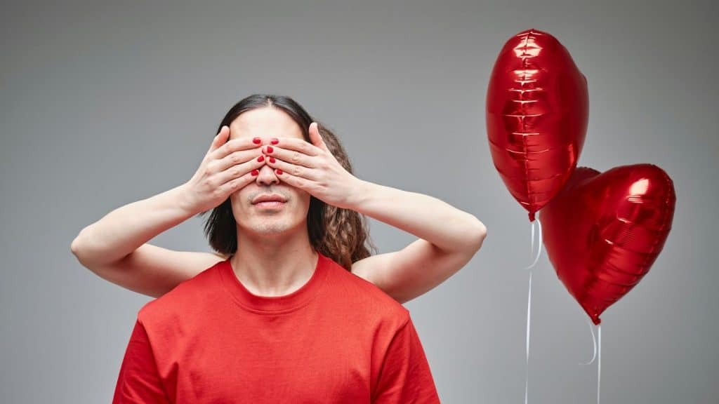 Woman covering a man’s eyes 