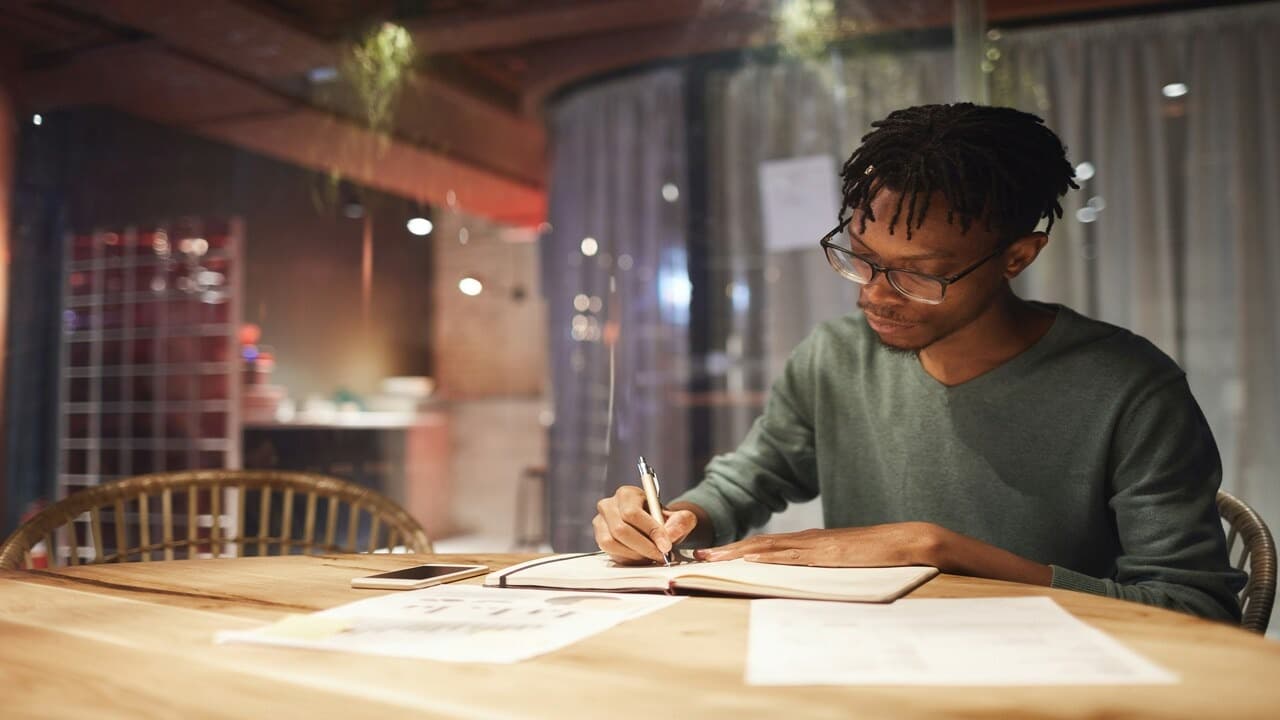 A man journaling by himself