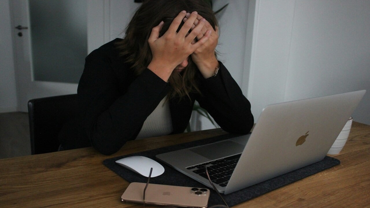 A woman looking stressed while working from home