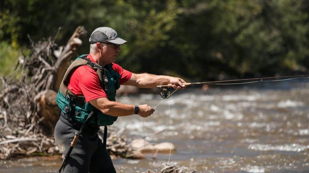 A man fly fishing in a river.