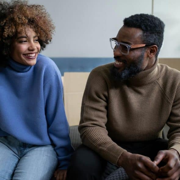 A man and woman smiling at each other