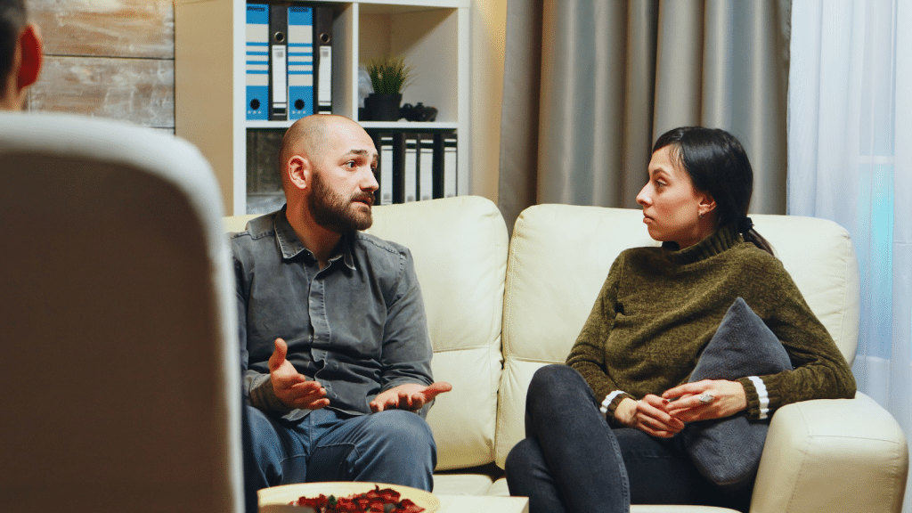 Couple having serious conversation on a couch