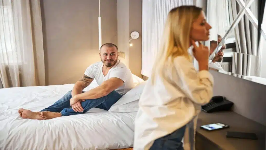 A man watching his wife getting ready