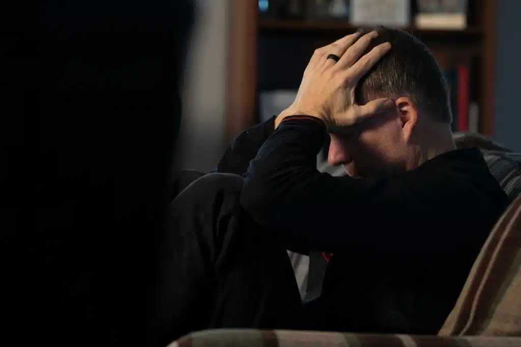 A man holding his head 