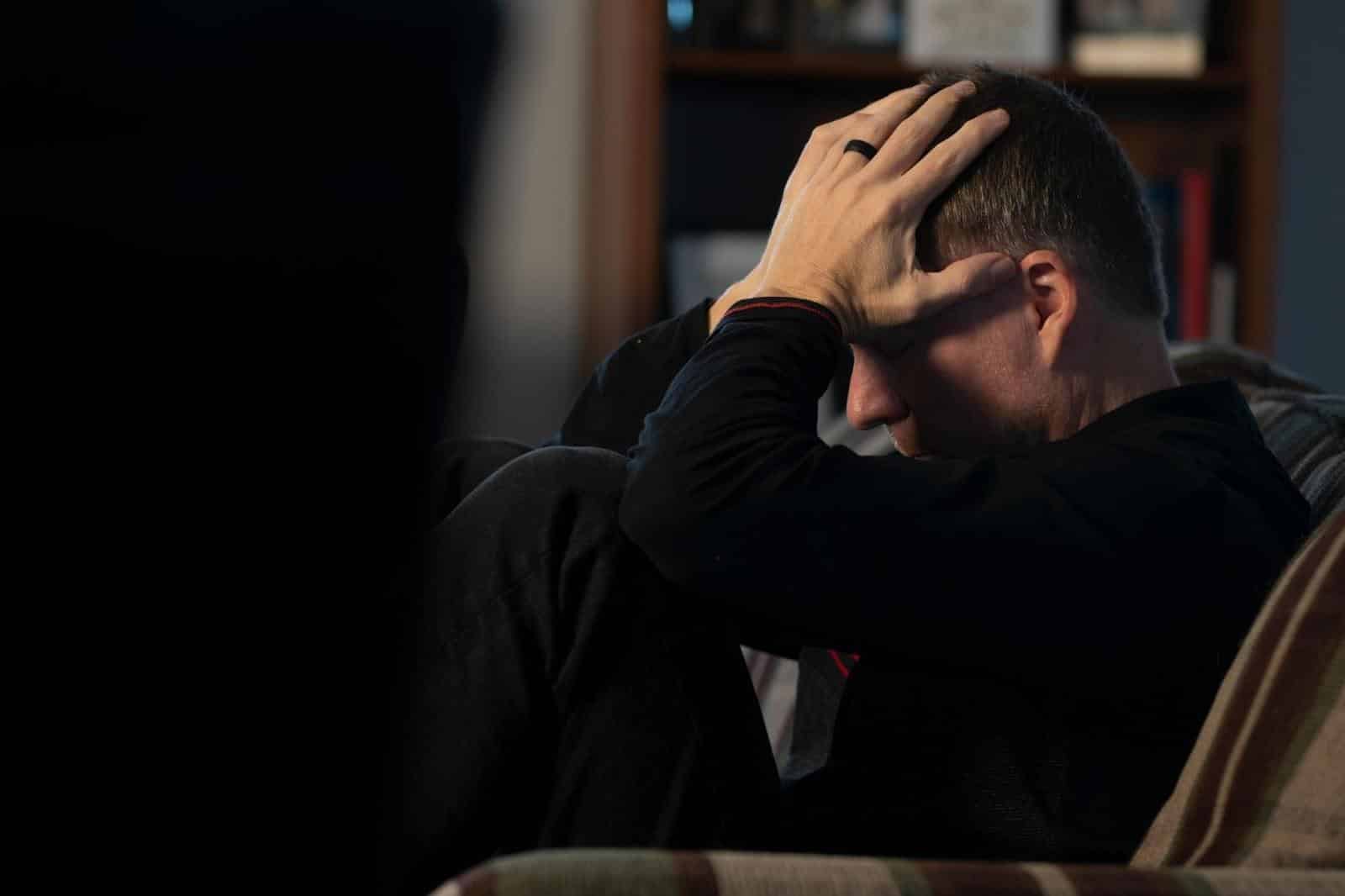 A man holding his head
